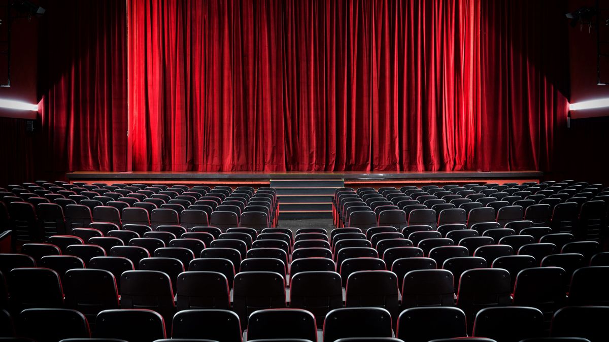 Darkened,Empty,Movie,Theatre,And,Stage,With,The,Red,Curtains