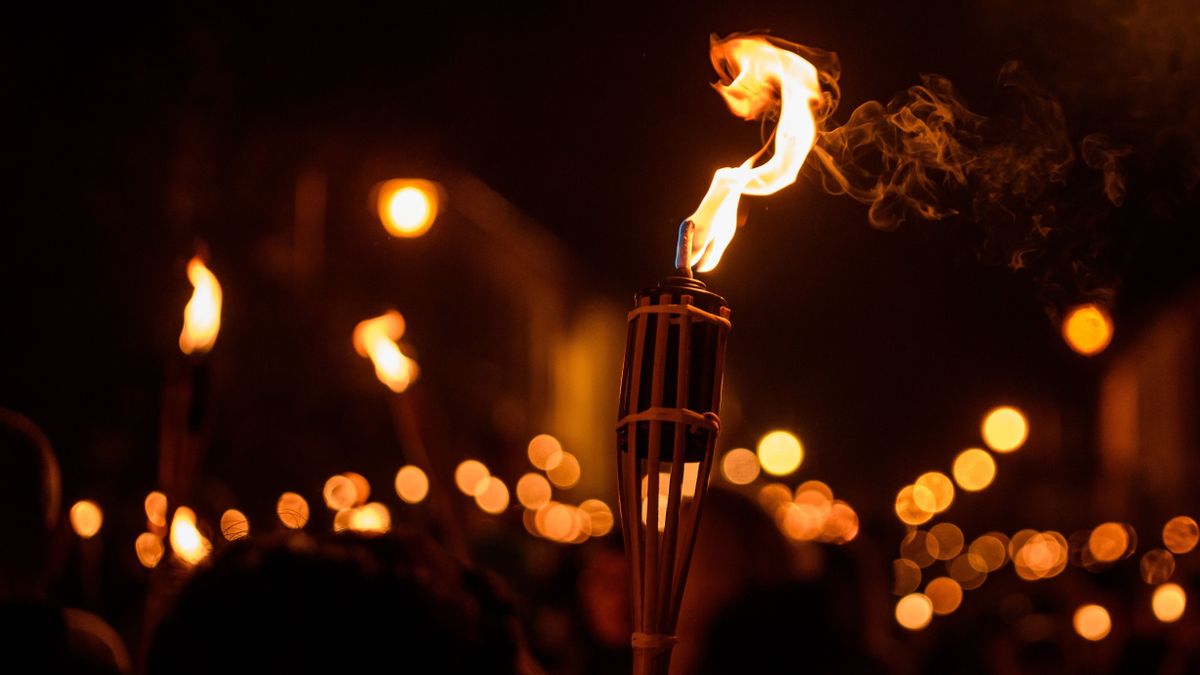 Burning,Torch,At,Night,In,A,Procession.,Bokeh.
