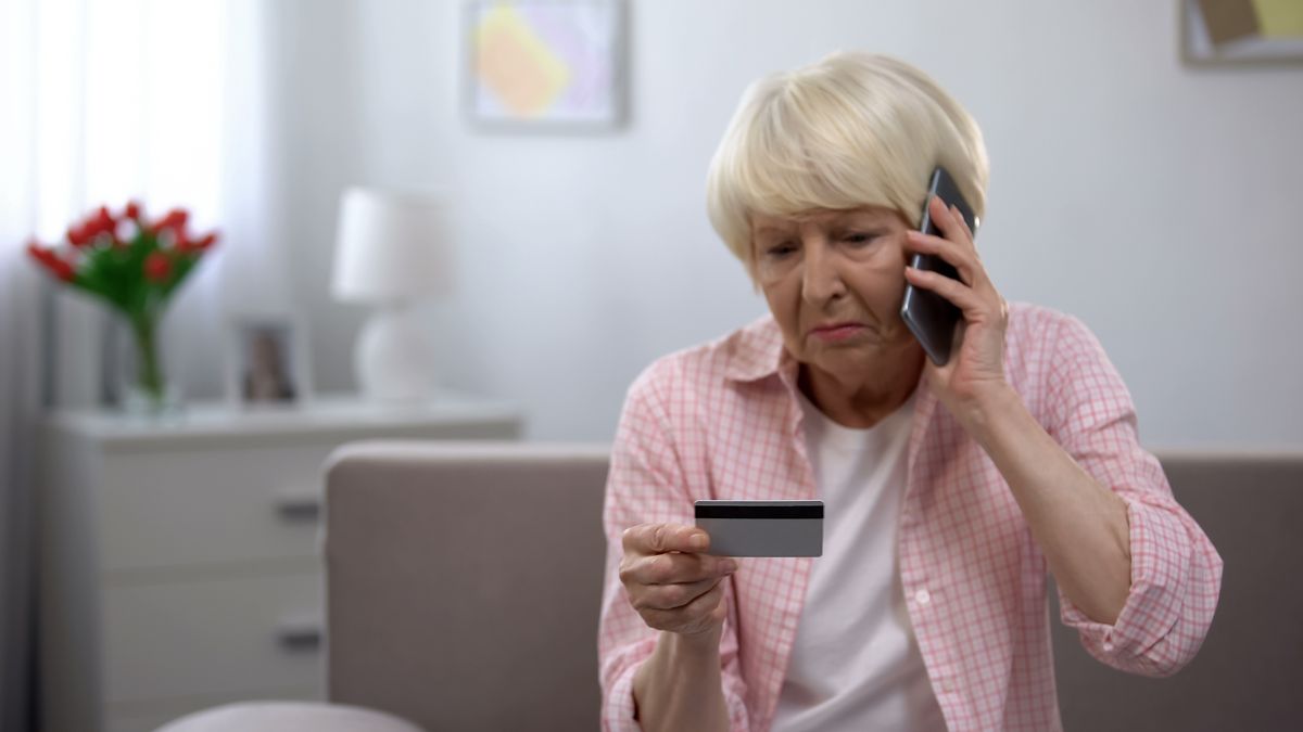 Sad,Old,Woman,With,Credit,Card,Calling,Bank,Support,,Reporting