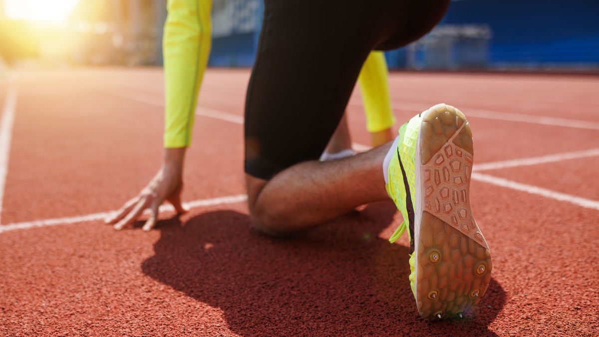 Running,Shoe,Of,Athletic,Runner,Training,In,Stadium,At,Sunset,