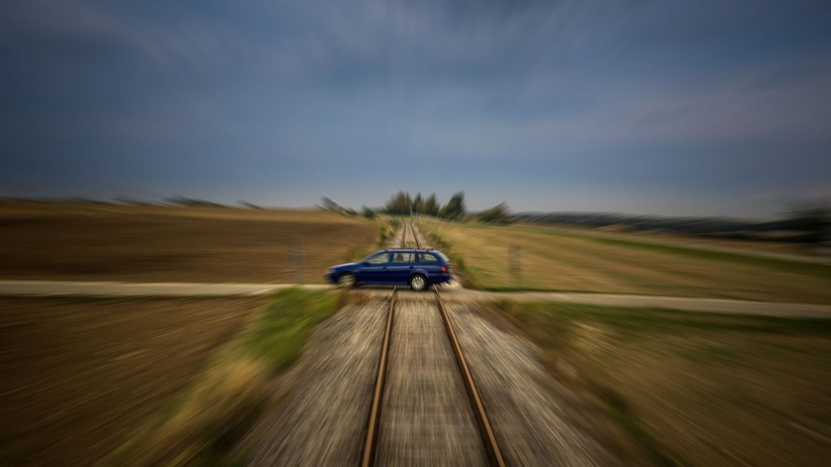 Train,Perspective,Of,A,Car,Passing,A,Railroad,Crossing,With