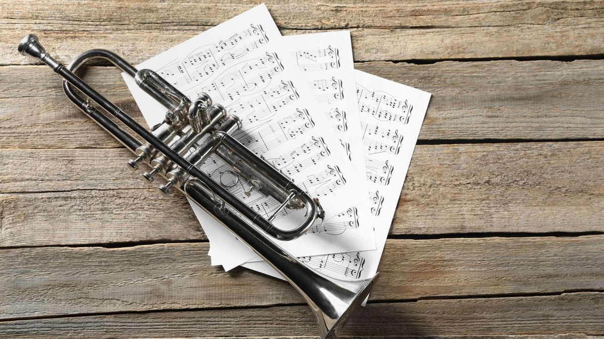 Trumpet,And,Music,Sheets,On,Wooden,Table,,Top,View