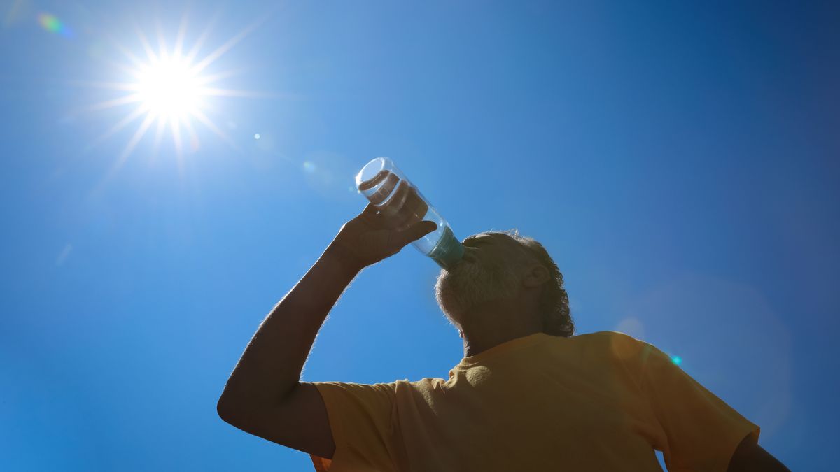 Senior,Man,Drinking,Water,To,Prevent,Heat,Stroke,Outdoors,,Low