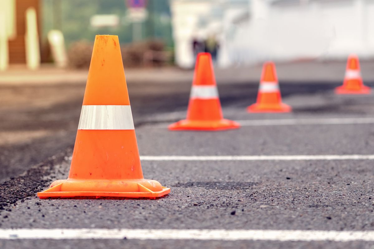 Rows,Of,Bright,Orange,Traffic,Cones,Placed,On,The,Asphalt