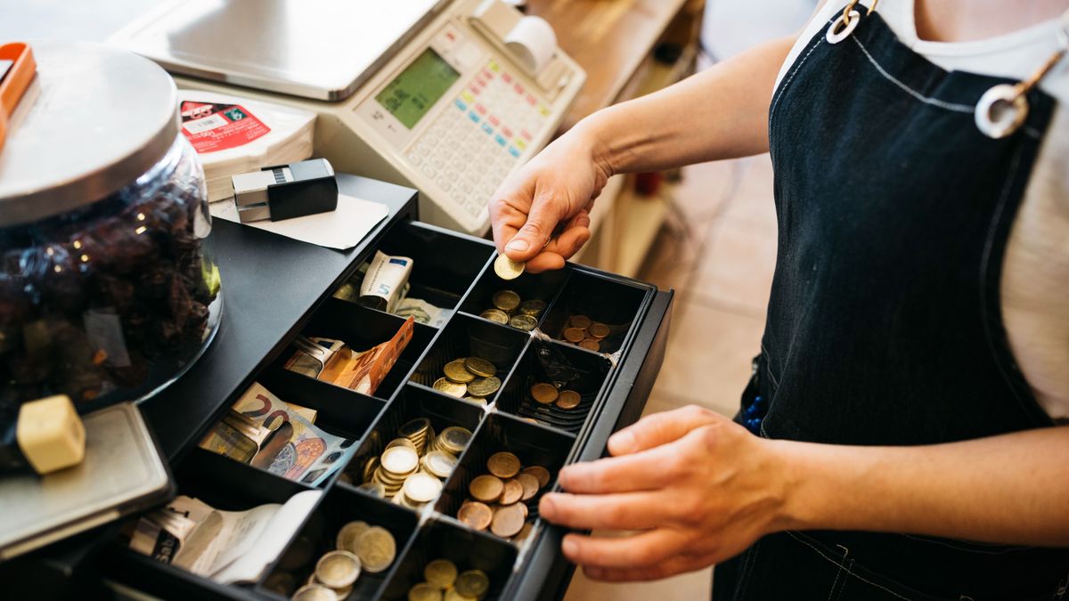 Woman using a cash till