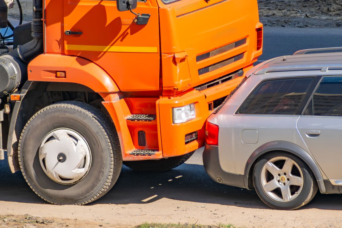 Car,Accident,Between,An,Orange,Truck,And,A,Passenger,Car.