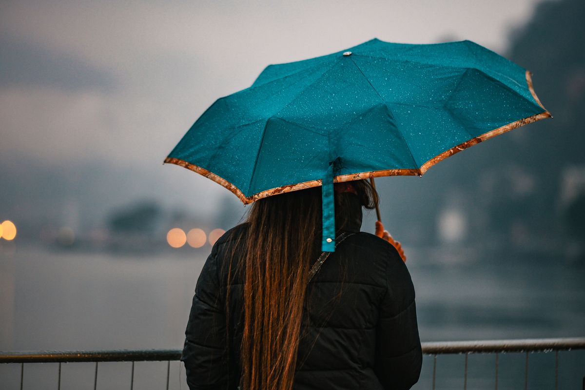Woman with umbrella while it's raining, Lake Como