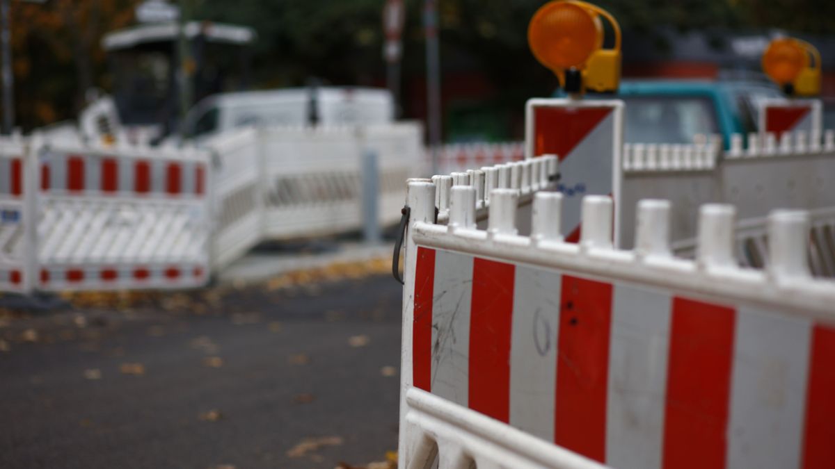 Red,And,White,Colored,Street,Barrier,At,An,Empty,Road.