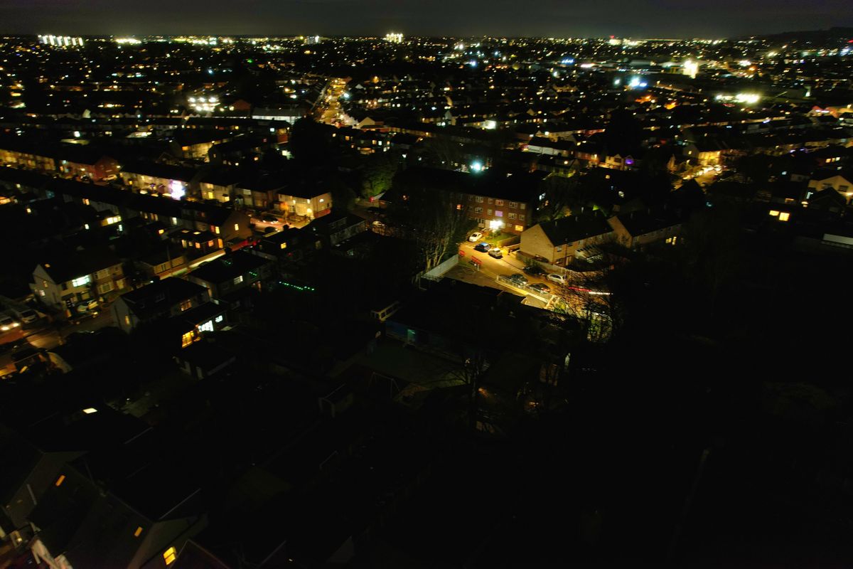 Aerial,View,Of,Illuminated,Luton,City,And,Downtown,Homes,During