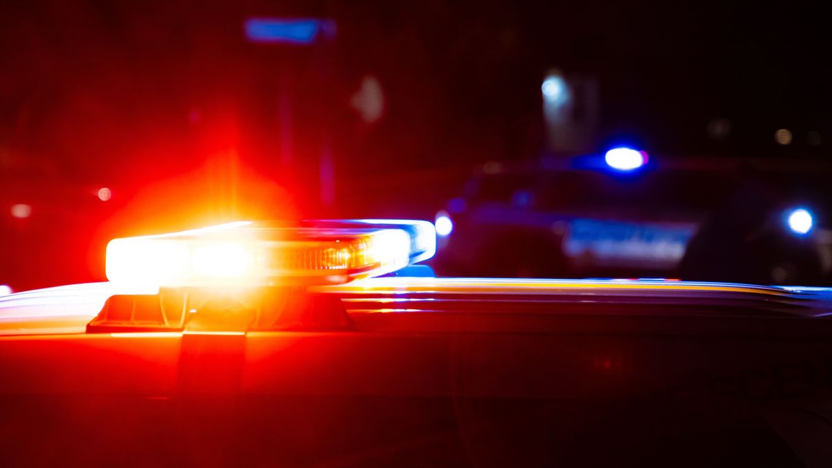 Red,And,Blue,Flashing,Lights,On,Police,Cars,At,A